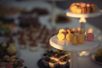 Closeup view photography of many small souffle cakes served on plate on table for cocktail party or on shelves of store. Christmas, birthday or wedding holiday dinner. catering food. tasty dessert.