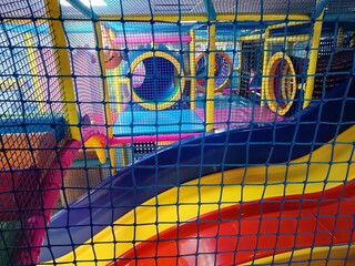 Playground entrance to the labyrinth with colorful tunnel and bridges, slides, children's room in play Entertainment center. Floor net steps to trampoline. Banner active leisure, free time kids photo