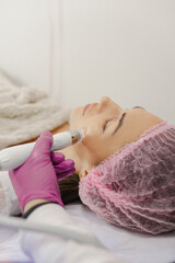 An hair removal master performs a hair removal procedure on a young client using various devices and a manipulator. Beauty salon for women's beauty and cosmetics close-up