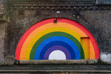 Rainbow flag painted on brick wall