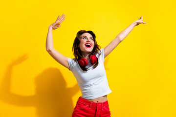 Photo of funky sweet woman dressed white t-shirt headphones having fun discotheque looking empty space isolated yellow color background - obrazy, fototapety, plakaty