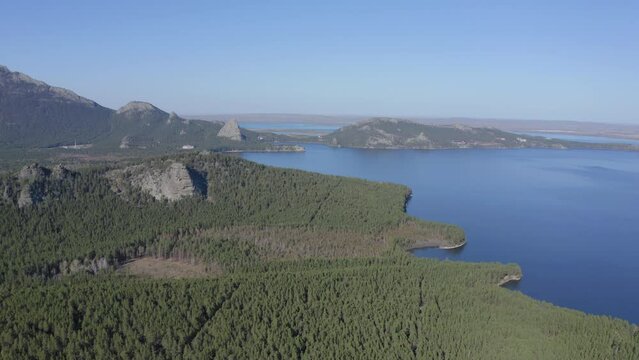 Aerial drone footage of rock remnant near the Lake Great Chebachye Lake in Natonal park Burabay Borovoe , Kazakhstan