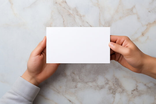 Woman holding blank business cardle background, top view. Mockup for design