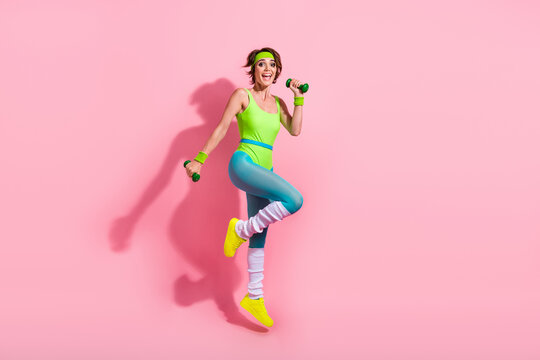 Photo of positive sportive coach lady practice body building with dumbbells isolated over pastel color background