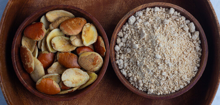 Ogbono Seed and ground ogbono in wooden bowls - African bush mango (Irvingia gabonensis) kernel