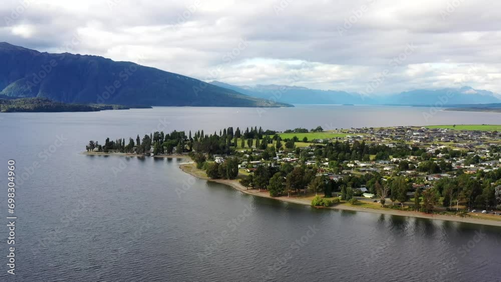 Wall mural Te Anau lake and town in New Zealand Fiordland to Milford Sound – aerial 4k.
