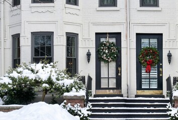 Fototapeta na wymiar Townhouse in winter with front door with Christmas wreath