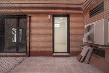 Interior patio of a house with a separating metal fence