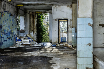 An abandoned building with many deteriorations, torn bags of material