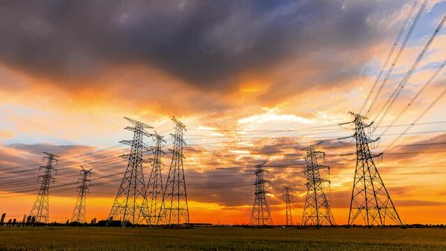 High voltage power tower and beautiful sky clouds at sunset