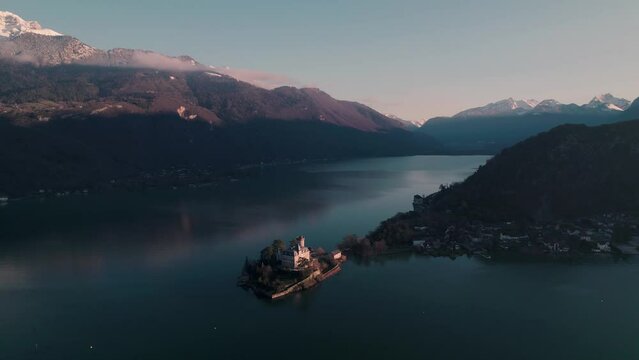 Aerial footage of Duingt Castle (Chateau de Duingt) on a peninsula in Annecy lake in Duingt, France