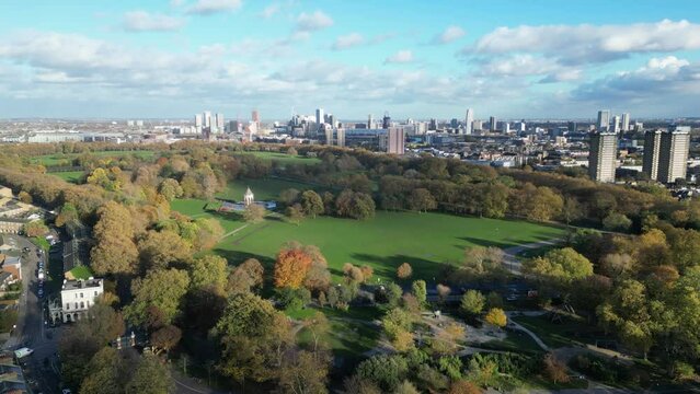 Aerial footage of Victoria Park on a sunny day with London skyline in the background, England, UK
