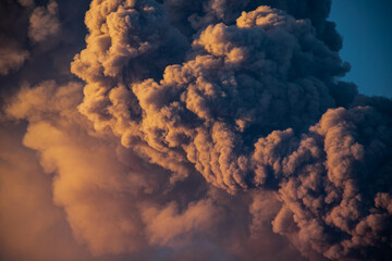 Scenic view of dark smoke in the sky at golden sunset