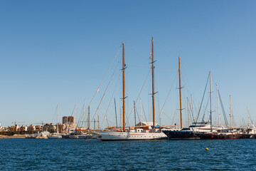 Fototapeta na wymiar Classic wooden sailing yachts stand in the marina.