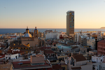Fototapeta premium View of the sea through the buildings in Alicante at sunset.