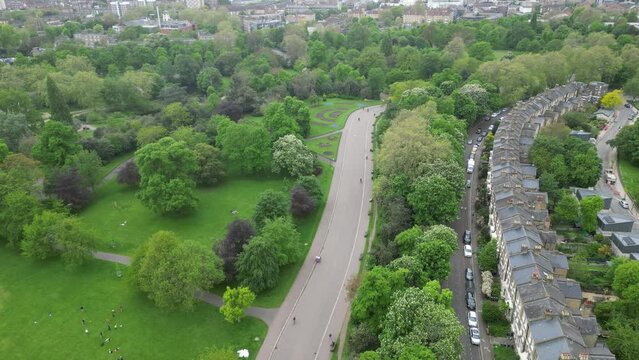 Aerial footage of people cycling and walking on a trail in Victoria Park in East London, England