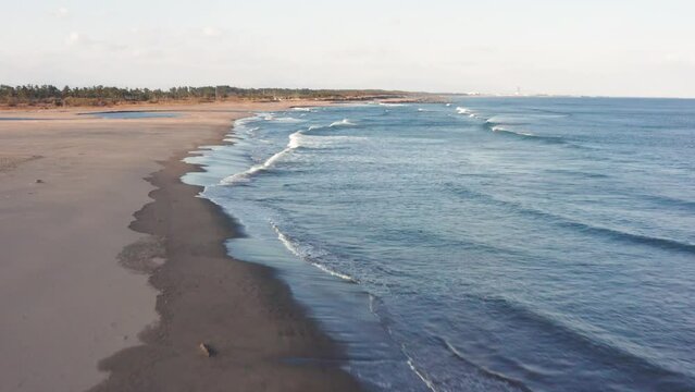 Drone flight over river and beach with waterbirds at sunset Miyazaki Japan