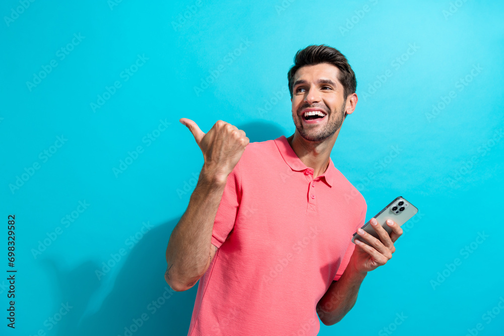 Poster photo of man blogger wear pink t shirt pointing finger empty space introduce website services using 