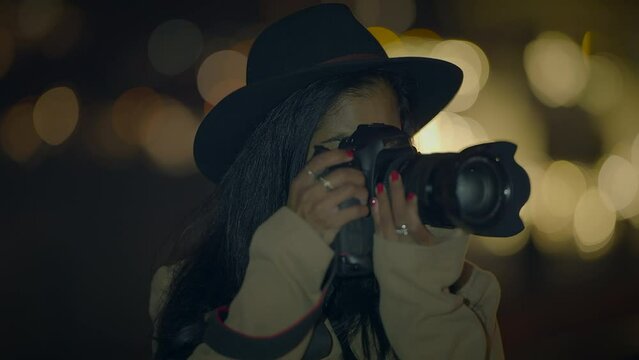 Lifestyle Portrait of Stylish Young Woman Wearing a Hat Holding Camera