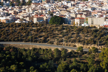 Deserted road without cars against the backdrop of the city.