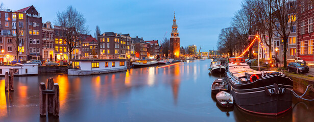 Panorama of Amsterdam canal Oudeschans and tower Montelbaanstoren, Holland, Netherlands.
