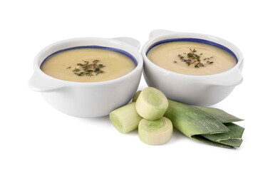 Bowls with tasty soup and cut leek isolated on white