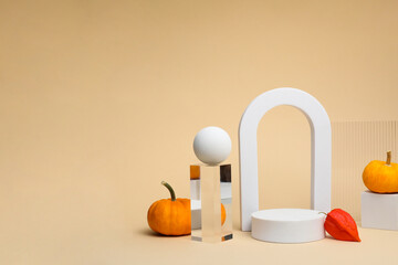 Autumn presentation for product. Geometric figures, pumpkins and physalis on beige background
