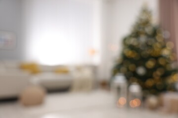 Christmas tree in furnished living room, blurred view. Festive interior design