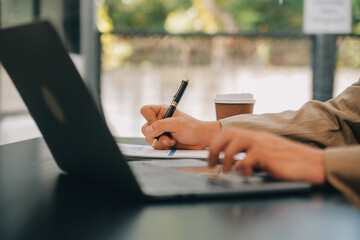 Entrepreneur Asian businessman and businesswoman discussing new business project in tablet in modern Meeting In Modern Office, Asian business casual concept.