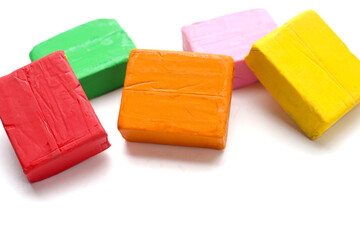 Colorful plasticine clay on white background.