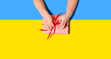 Little boy making a gift box from above overhead view