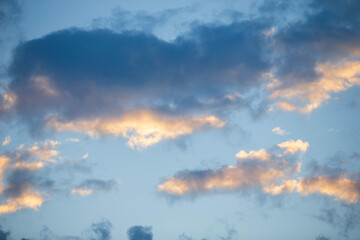 Cloudscape, Colored Clouds at Sunset near the Ocean on a Blue Sky