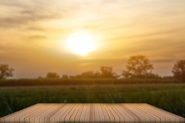 Wooden table whit blur sunset background