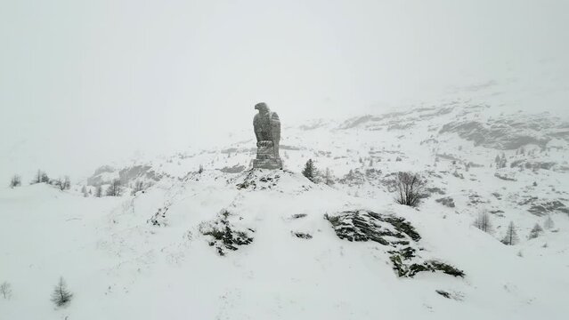 Golden Eagle Monument Over Simplon Pass In Winterly Landscape In Switzerland. Aerial Drone Shot