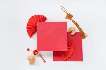 Blank card with fans, fortune cookies and decorations on white background. Chinese New Year...