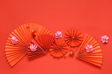 Fans with beautiful flowers and lanterns on red background. Chinese New Year celebration