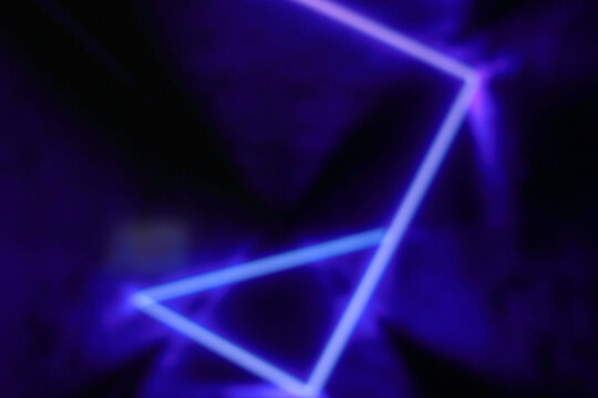 Defocused image of purple neon light blur background