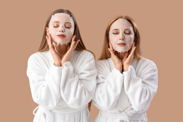 Young woman and her mother in bathrobes with facial sheet masks on beige background