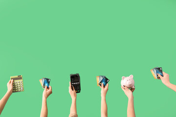 Women with credit cards, calculator, payment terminal and piggy bank on green background