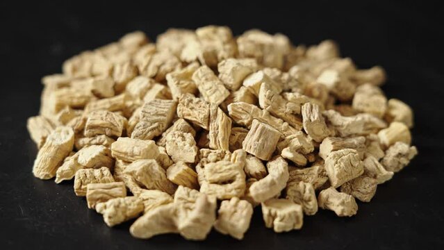 Chinese herb medicine codonopsis root on black background.