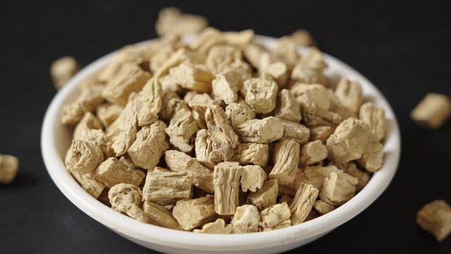Chinese herb medicine codonopsis root on black background.