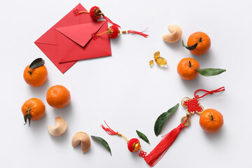 Frame made from red envelopes, tangerines and Chinese symbols on white background. New Year...
