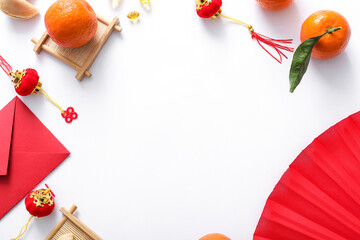 Frame made from red envelope, fortune cookies, tangerines and Chinese symbols on white background. New Year celebration - obrazy, fototapety, plakaty