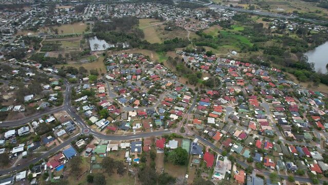 Houses And Buildings In Loganholme, Suburb In The City Of Logan In Queensland, Australia. aerial tilt-up shot