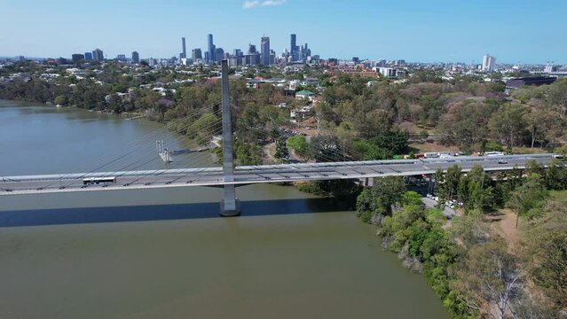 Eleanor Schonell Bridge Across Brisbane River In Queensland, Australia. Brisbane Skyline In Distant Background. aerial pan left shot