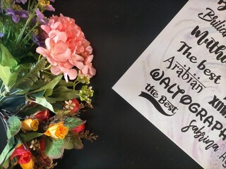 bouquet of flowers and alfabet on black background © RUS