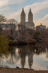 Fototapeta na wymiar Views of a lake in Central Park, New York. You can see the reflection of the buildings in the lake. Photograph taken in high key.