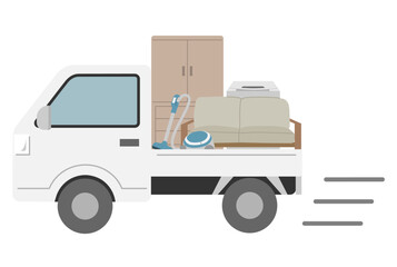 不用品を積んだ走る軽トラック