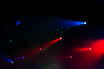 Modern stage illumination. Colorful scenic spot lights glow in smoke