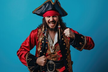 Studio photo of a pirate on a blue background. The captain has a beard, a hat and a suit.